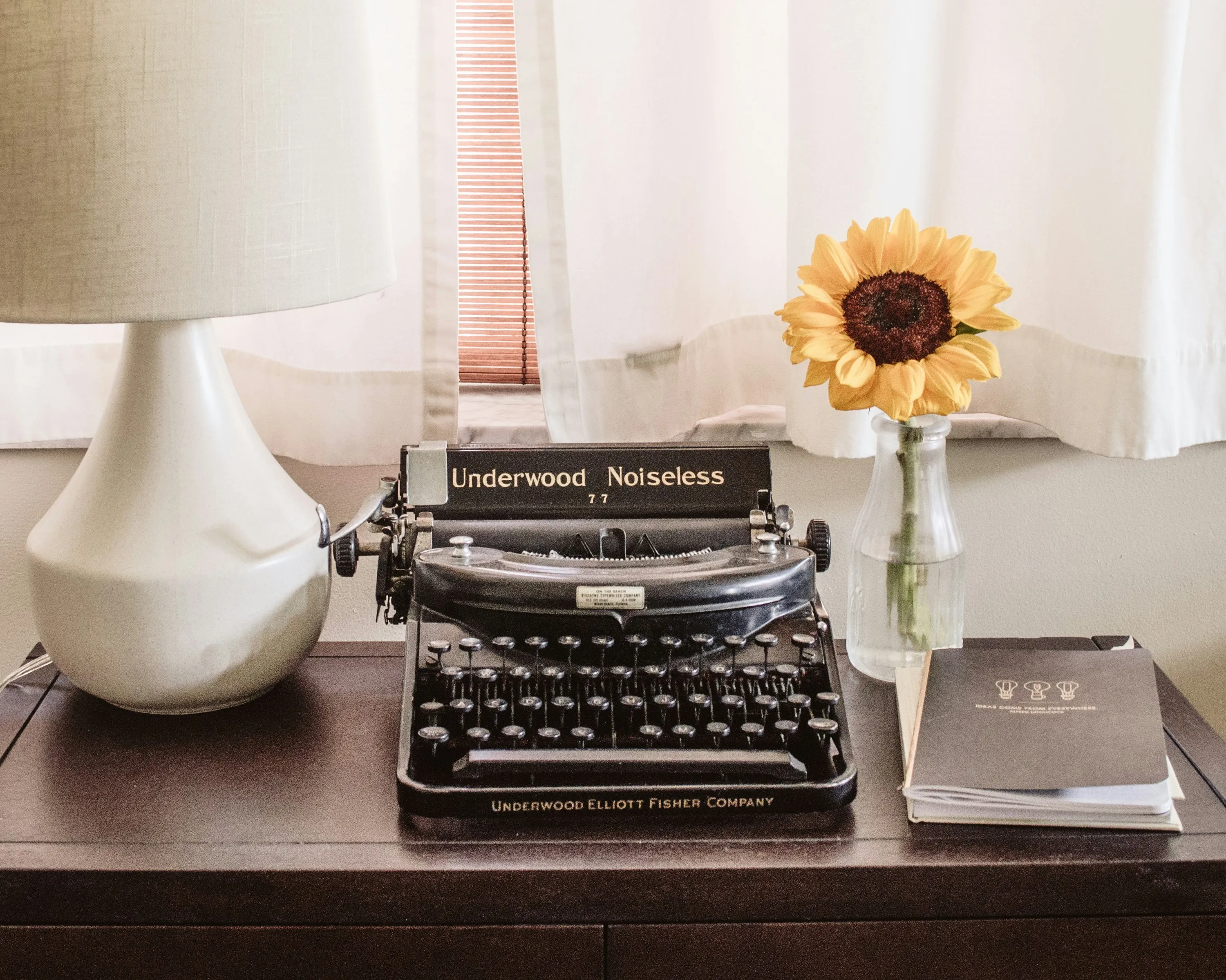 laptop, notebook, and a coffee cup on a desk