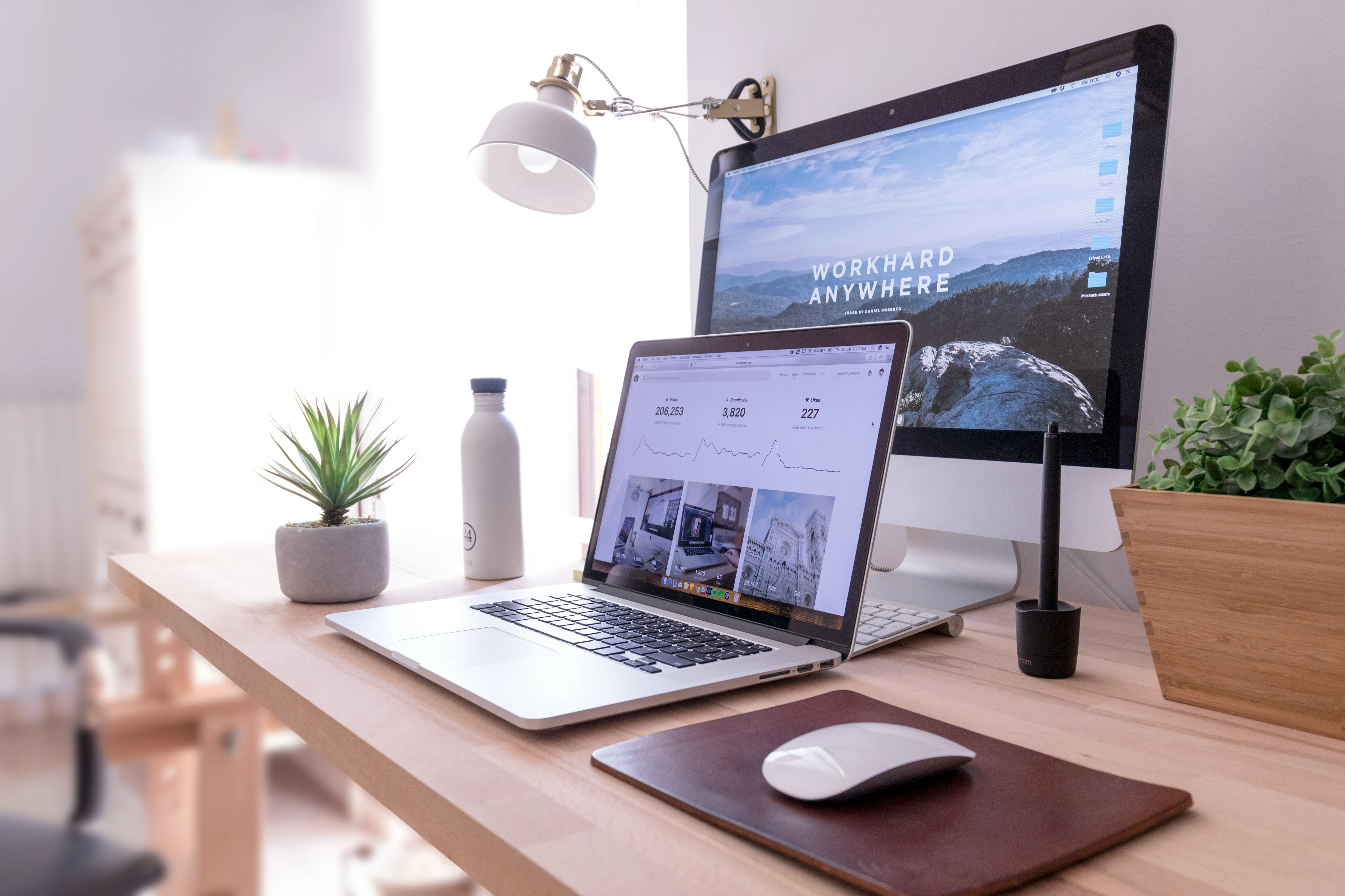 computer and laptop on a desk