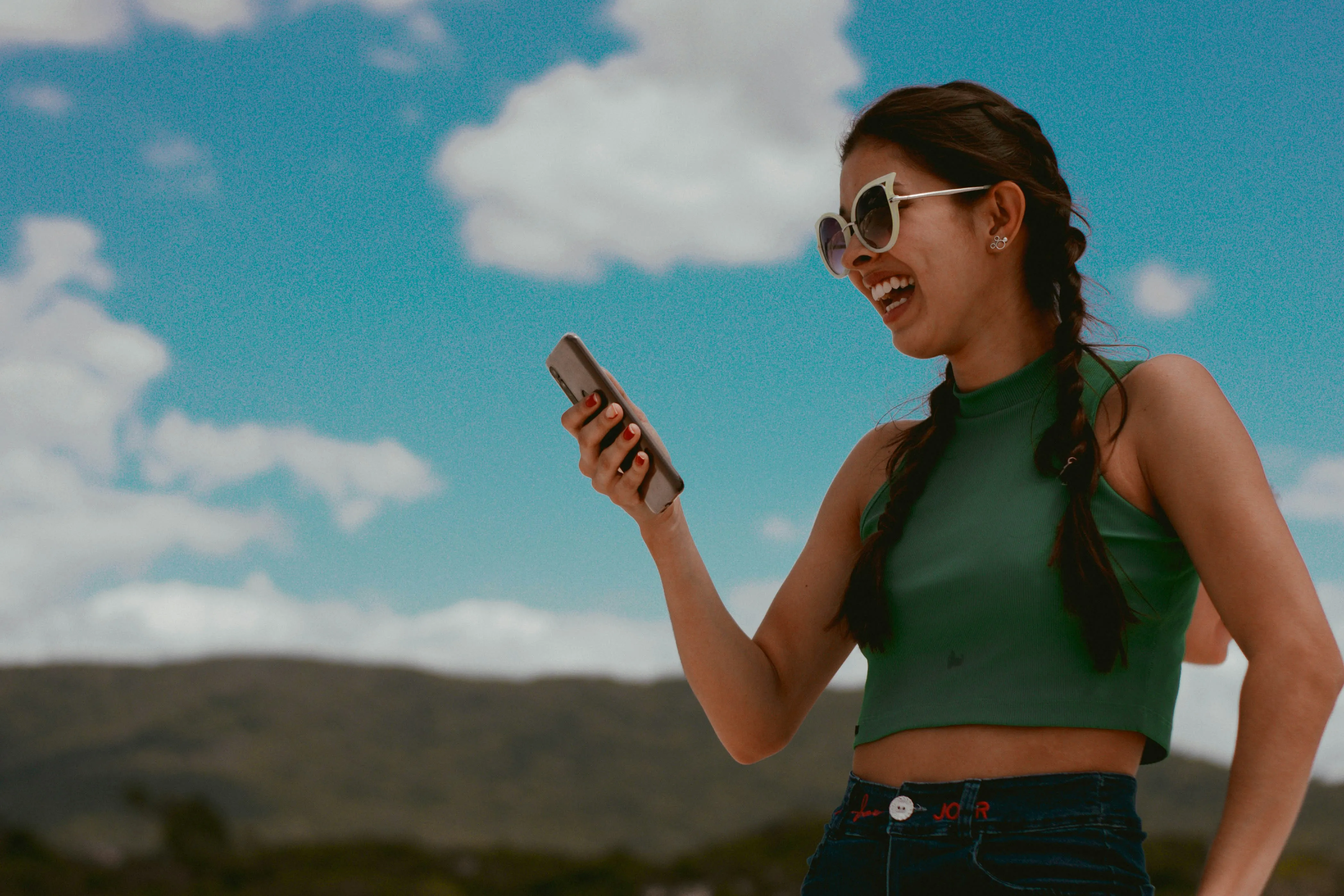 woman-looking-on-her-smartphone-and-laughing